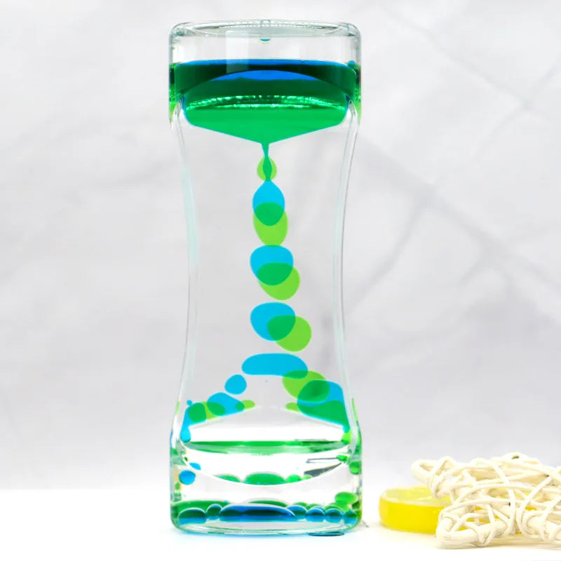 Glass container with blue and green liquid and a yellow lid on a white background