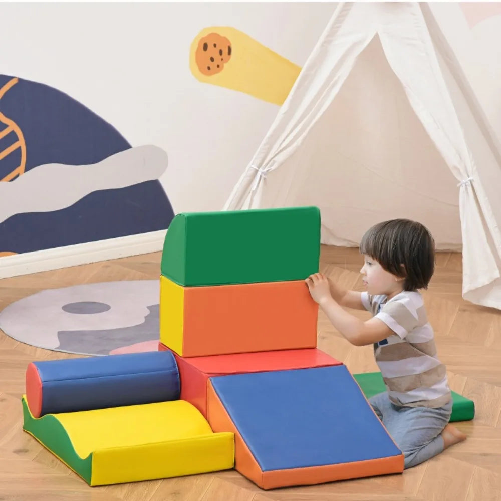 Child playing with colorful foam blocks on a wooden floor.