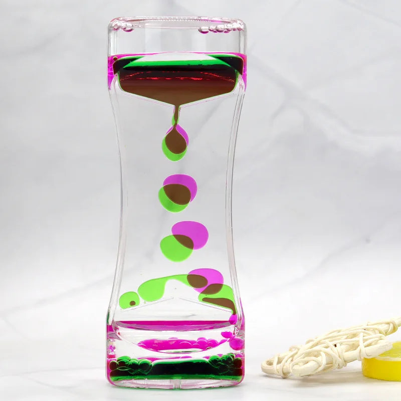 Glass container with colorful liquid and floating objects on a white background