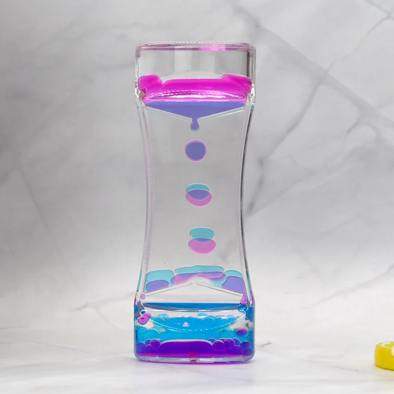 Clear container with colorful liquid and lid on a white background